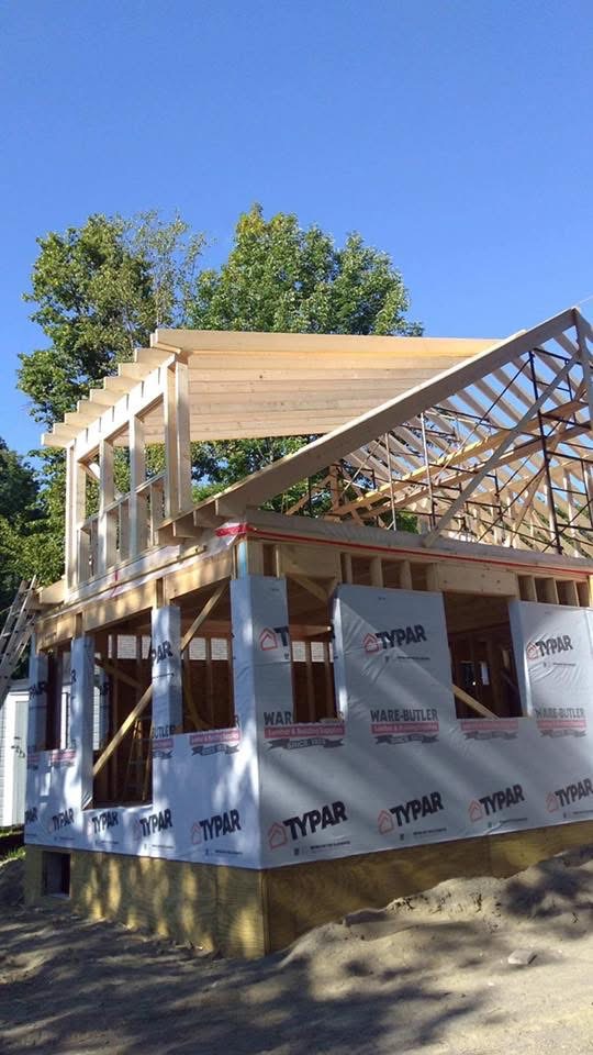 Framed home addition with roof trusses and Typar house wrap in progress