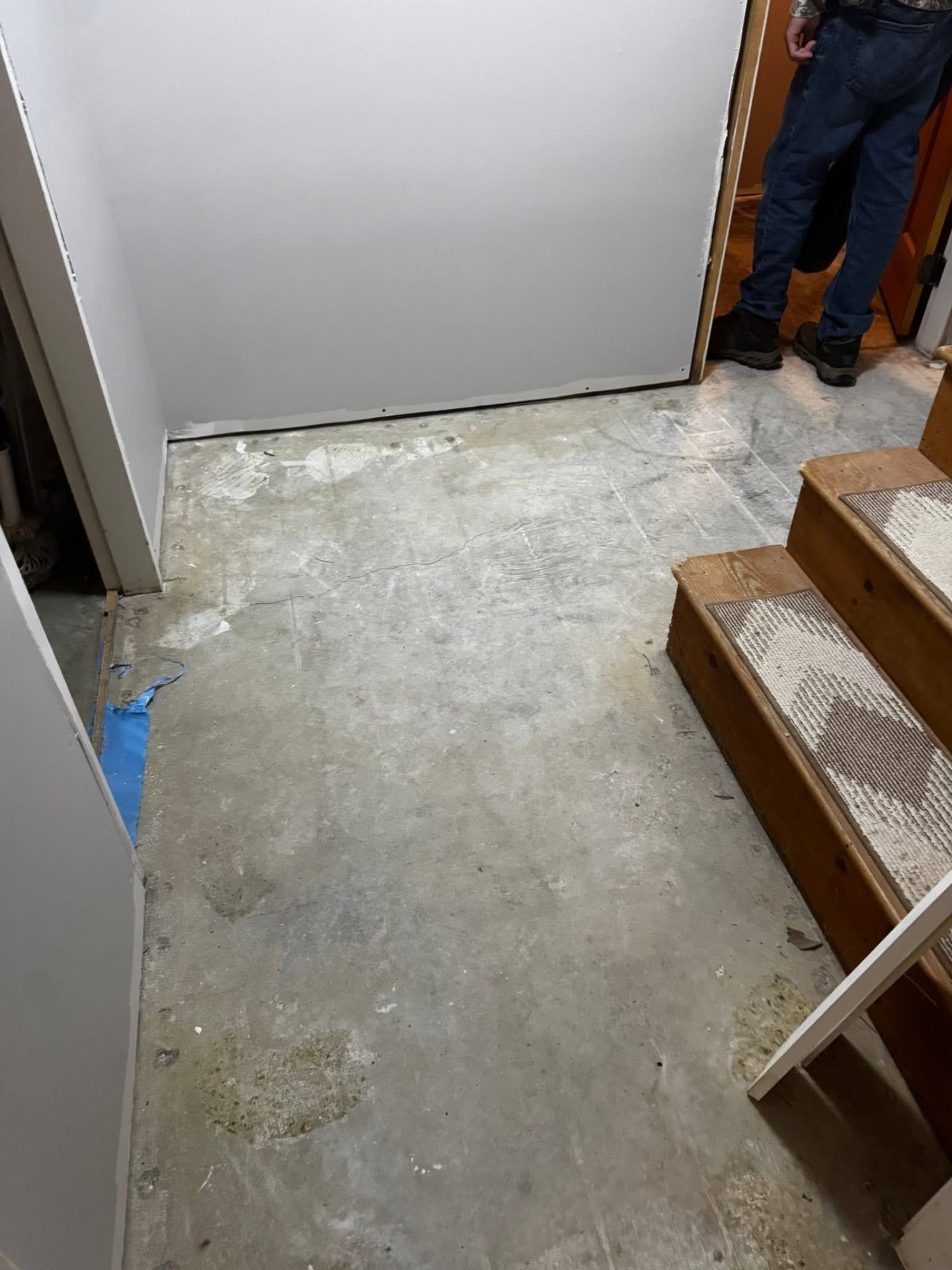 Bare concrete entryway floor before flooring installation