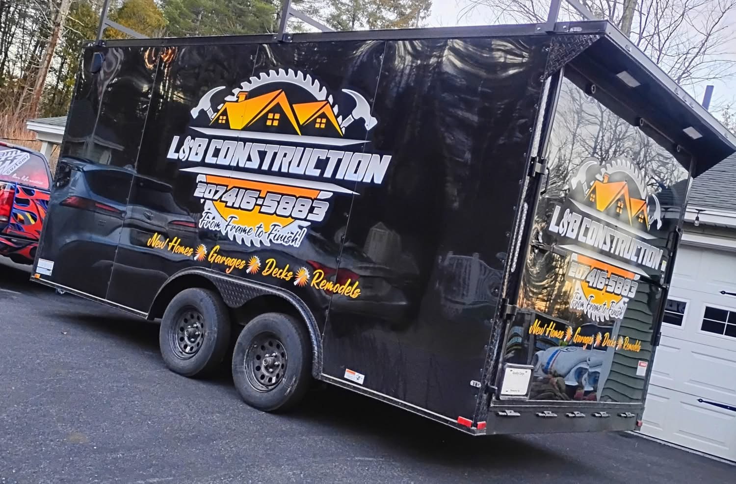 L & B Construction branded work trailer on-site