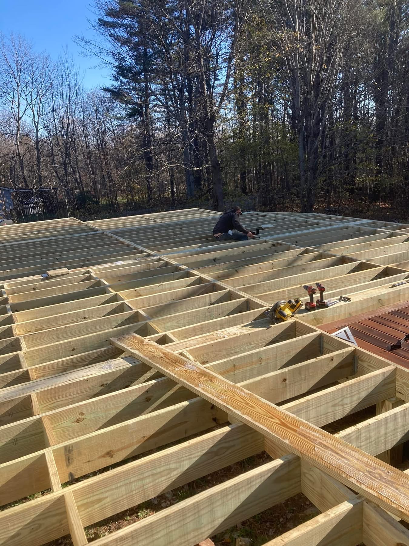 Pressure-treated deck framing and joists in progress