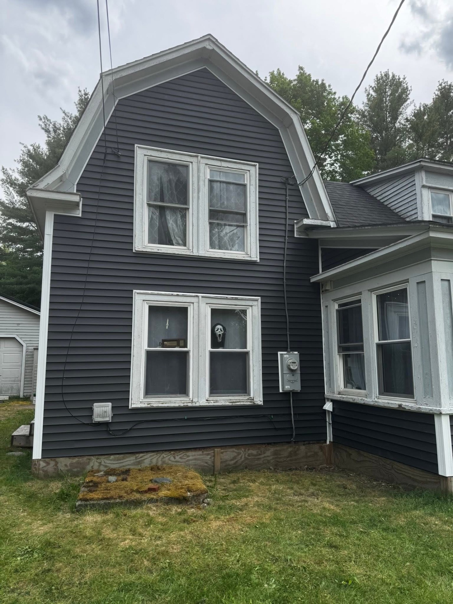 Home with new dark vinyl siding and clean white trim