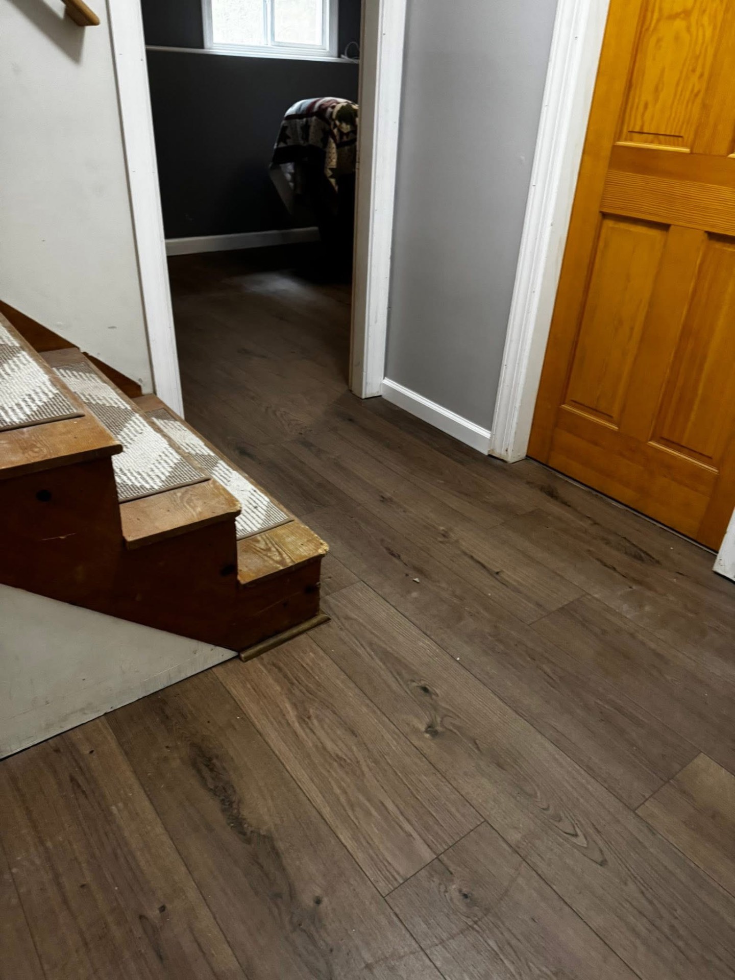 Finished entryway with warm brown vinyl plank flooring
