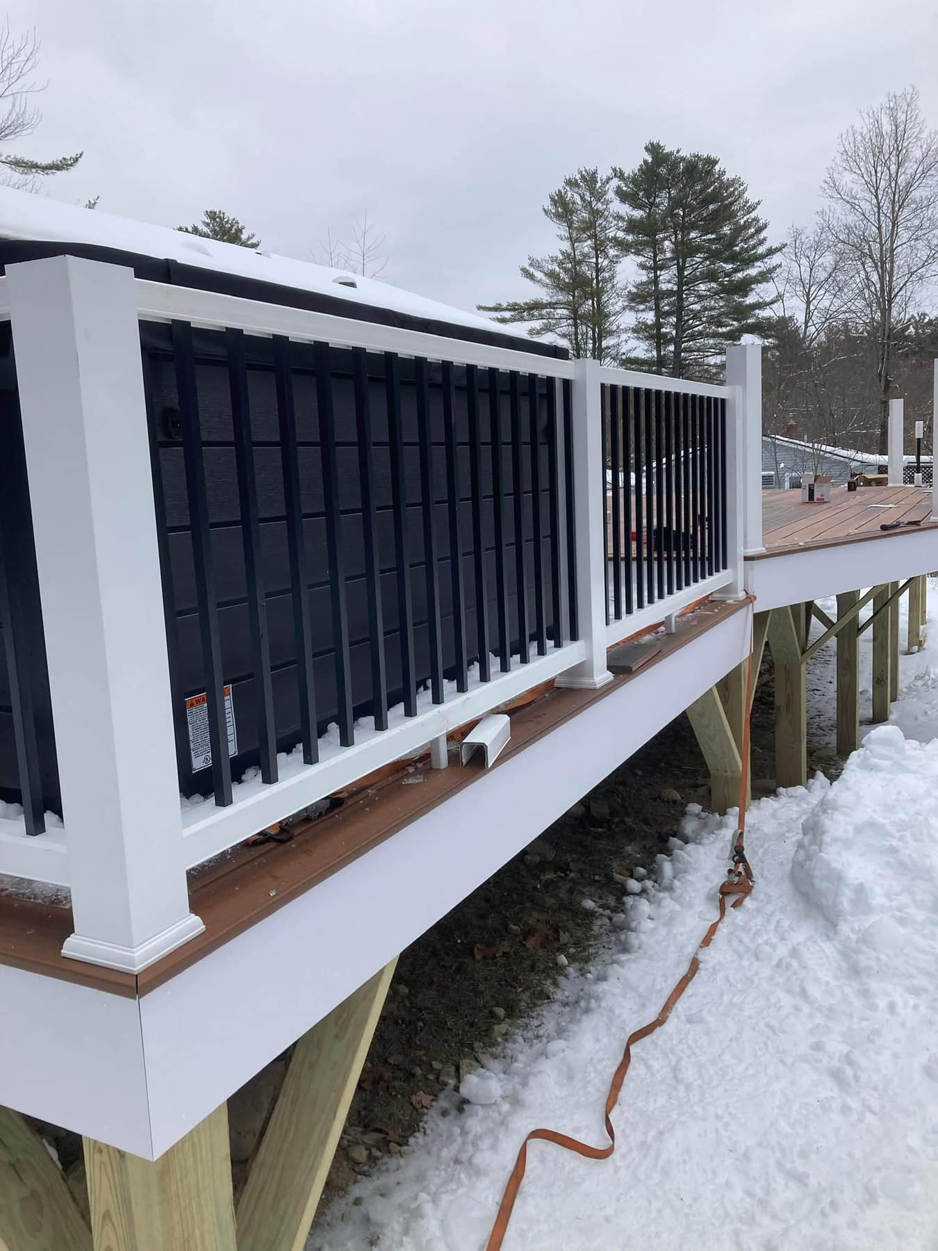Large elevated composite deck with white railings and black balusters