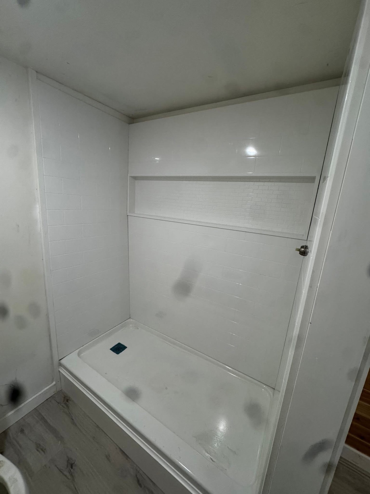 New subway-tile shower surround with built-in niche