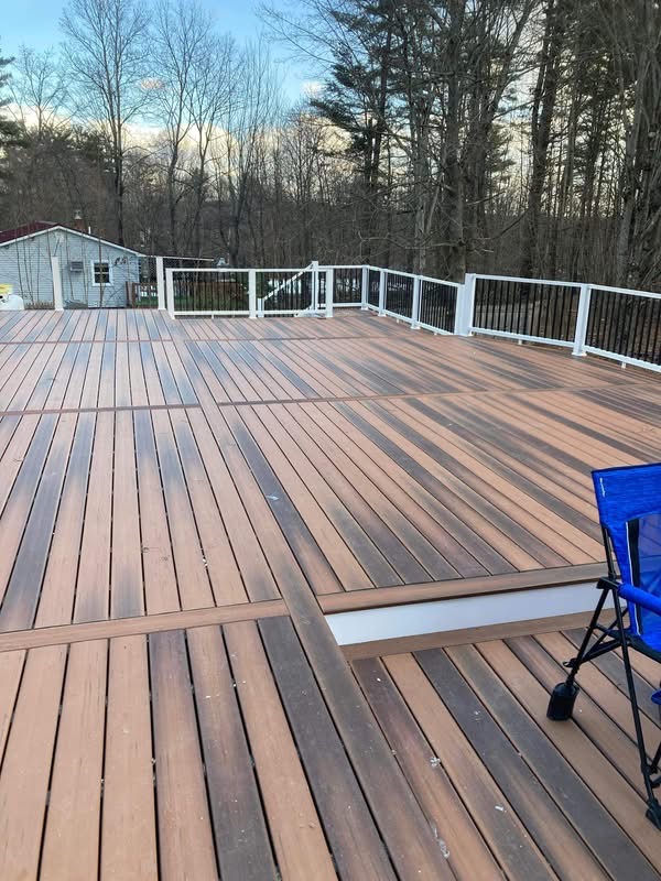 Large elevated composite deck with white railings built by L & B Construction