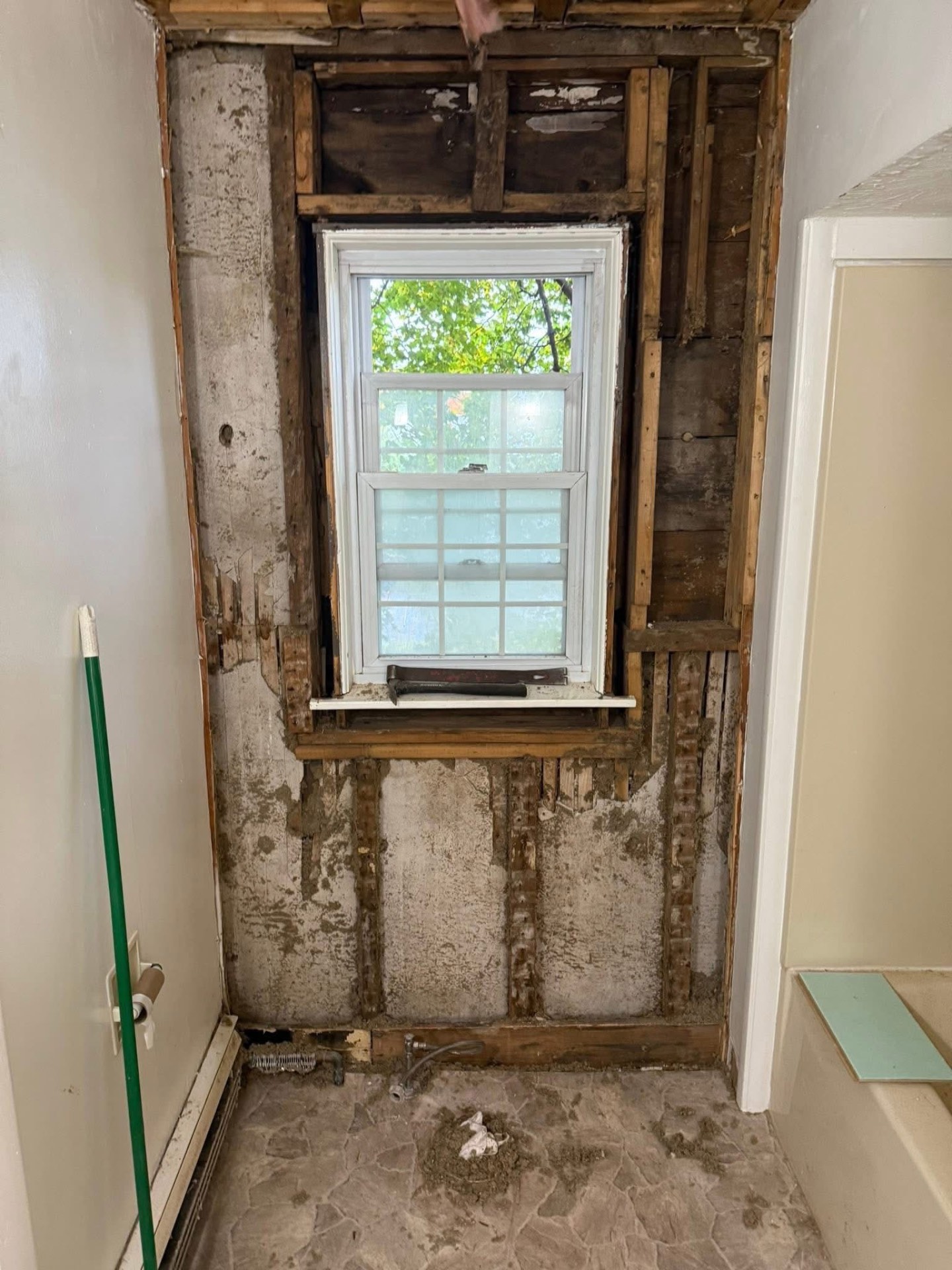Bathroom stripped to the framing around a window