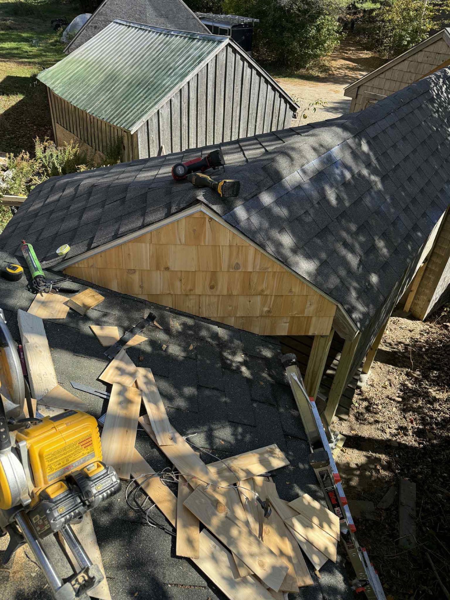 Completed addition with shingled roof and cedar shake gable