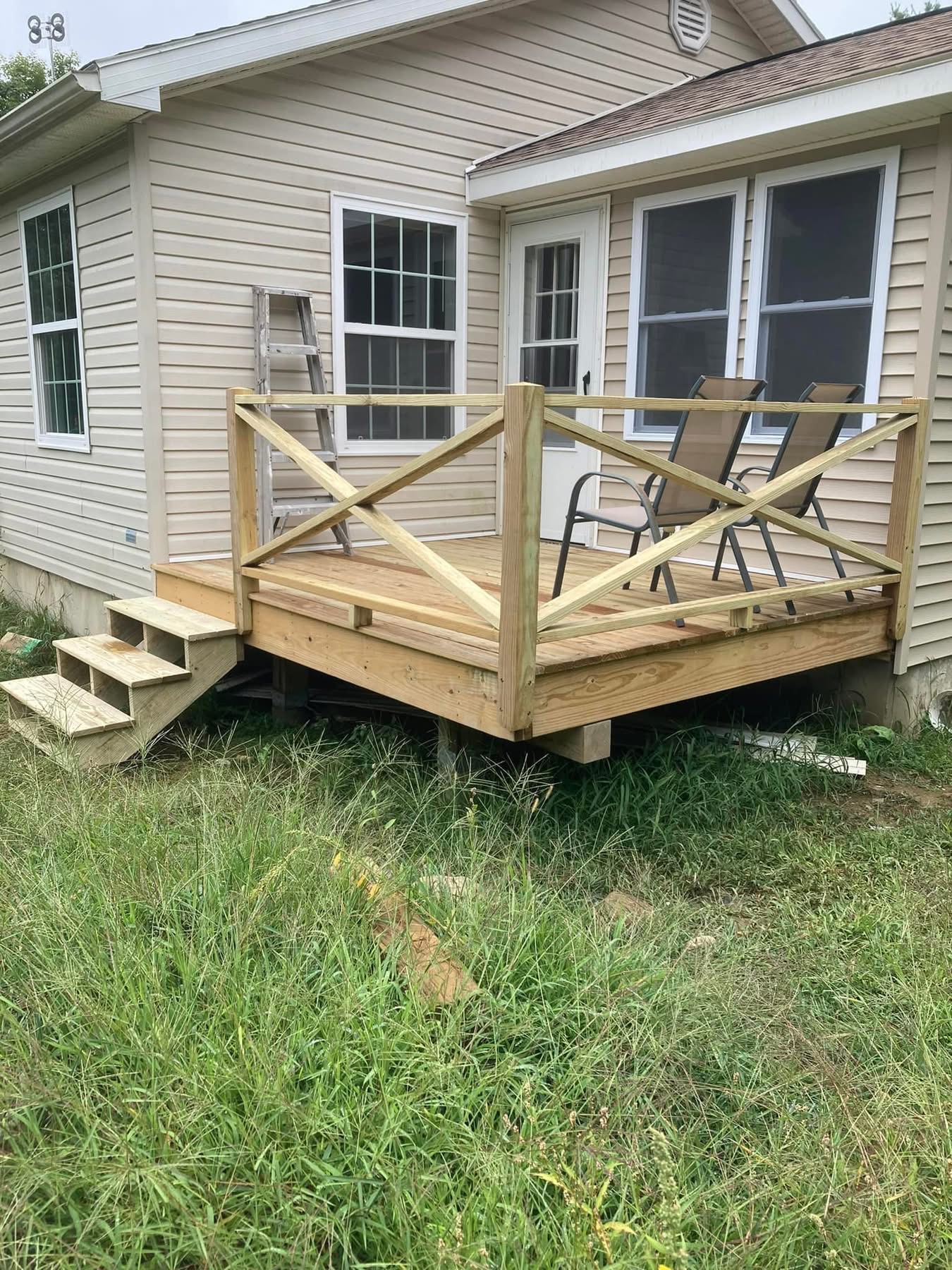 Finished back porch deck with pressure-treated railing and stairs