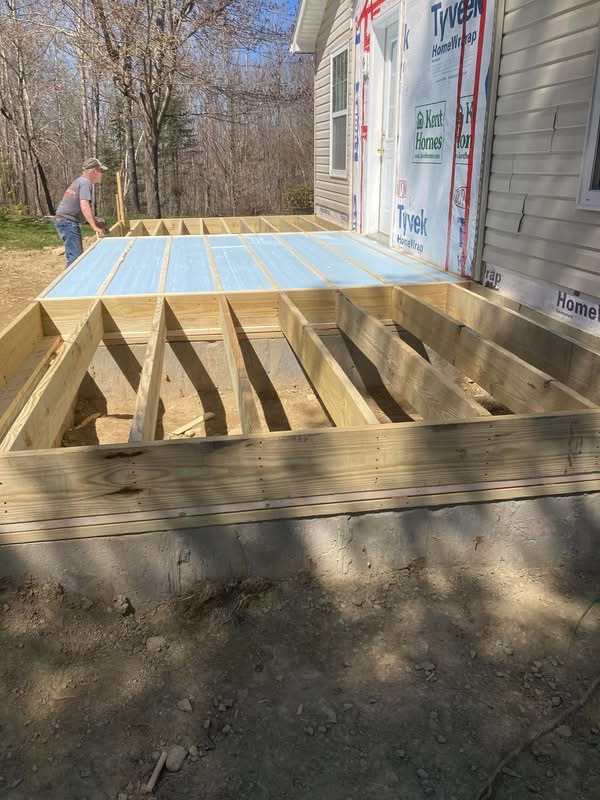Deck framing attached to a home, ready for decking boards
